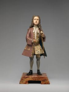Clay and wood portrait figurine of a European merchant.